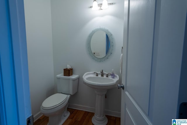 bathroom with hardwood / wood-style floors and toilet