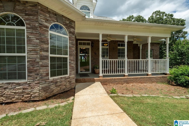 property entrance with a porch and a lawn