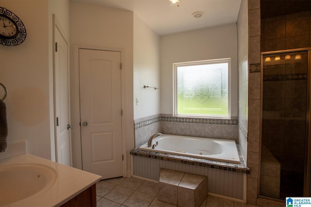 bathroom with tile patterned flooring, vanity, and plus walk in shower