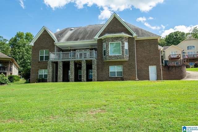 rear view of house with a balcony and a yard