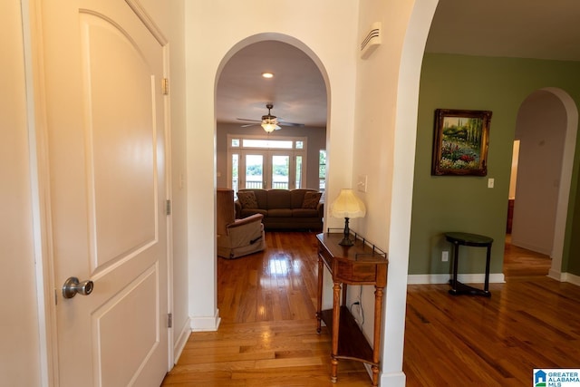 corridor with hardwood / wood-style flooring