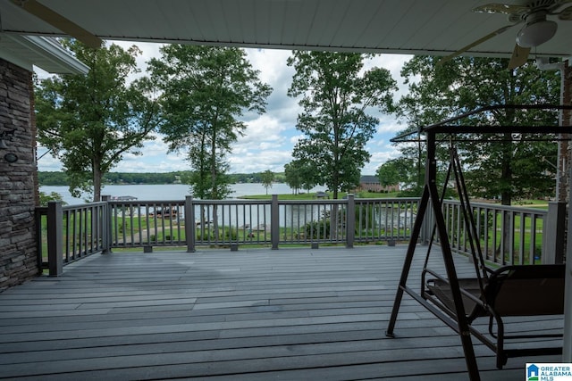 wooden deck with a water view and ceiling fan