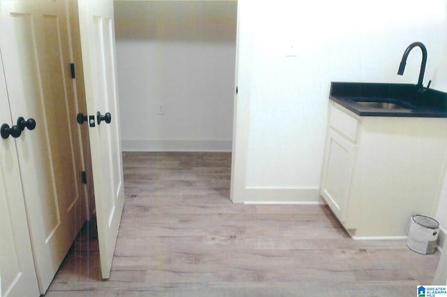 interior space featuring wood-type flooring and vanity