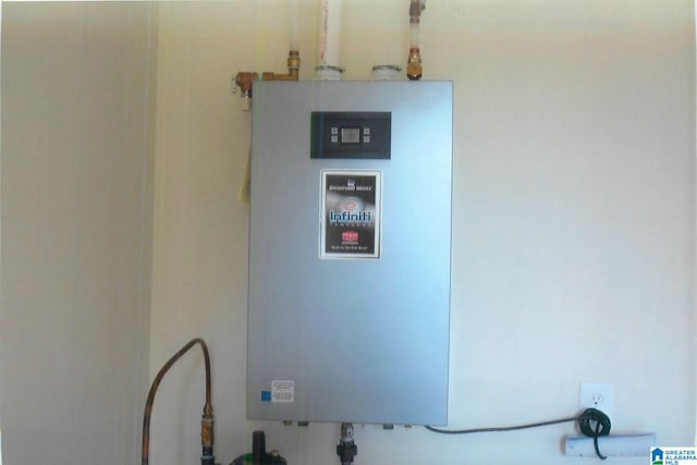 utility room featuring tankless water heater