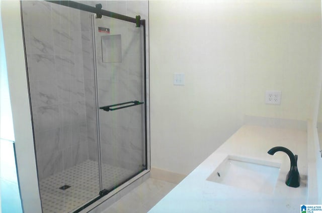 bathroom featuring vanity and a shower with shower door