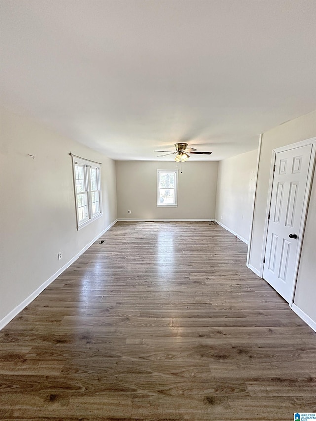 unfurnished room featuring dark hardwood / wood-style flooring and ceiling fan