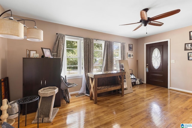 foyer entrance featuring ceiling fan and light wood-type flooring