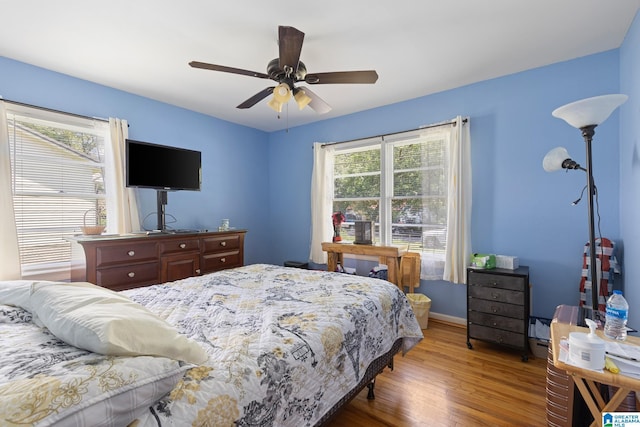 bedroom with ceiling fan and hardwood / wood-style floors