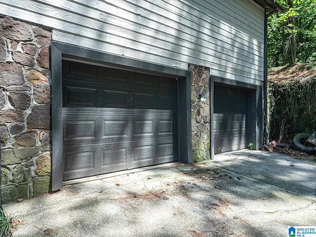 garage with concrete driveway