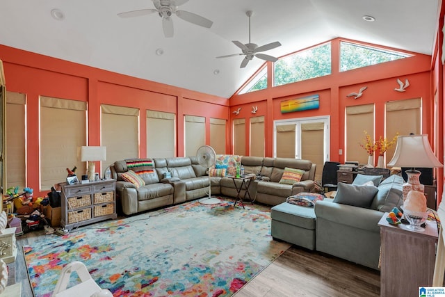 living room with ceiling fan, wood-type flooring, and high vaulted ceiling