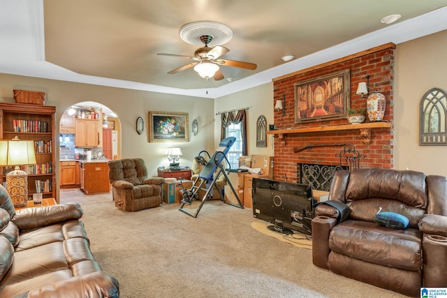 living room with ceiling fan, light colored carpet, and a brick fireplace