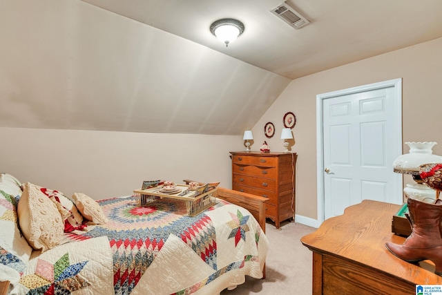 bedroom with lofted ceiling and light colored carpet