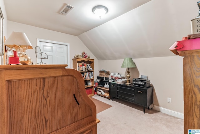 bedroom with vaulted ceiling and light colored carpet