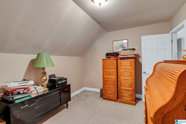 office space with vaulted ceiling and light colored carpet