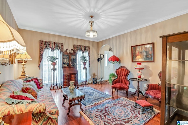 sitting room featuring wood-type flooring and ornamental molding