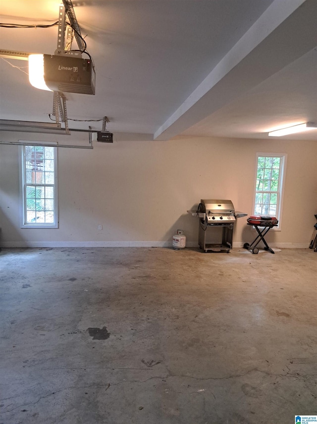 garage with a garage door opener and baseboards
