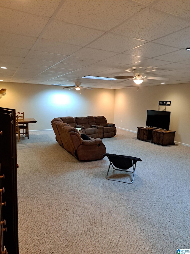 carpeted living area featuring baseboards, ceiling fan, and a paneled ceiling
