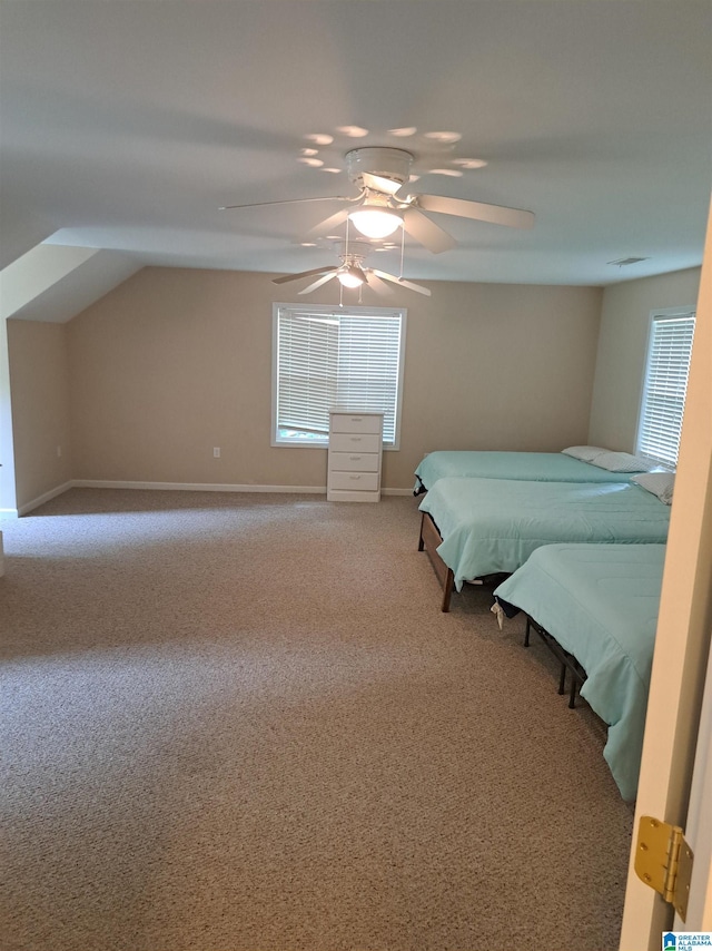 carpeted bedroom with baseboards, a ceiling fan, and lofted ceiling