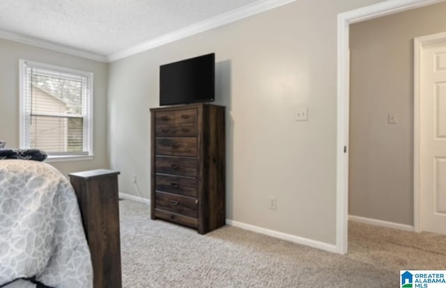 carpeted bedroom featuring ornamental molding and a textured ceiling