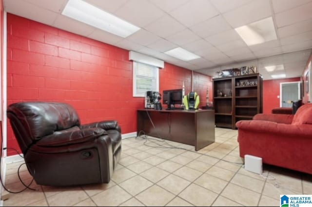 office space with a paneled ceiling and light tile patterned floors