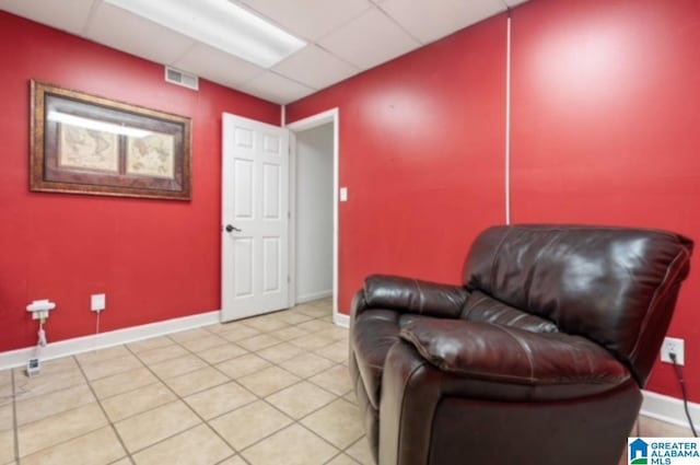 sitting room with light tile patterned flooring and a drop ceiling