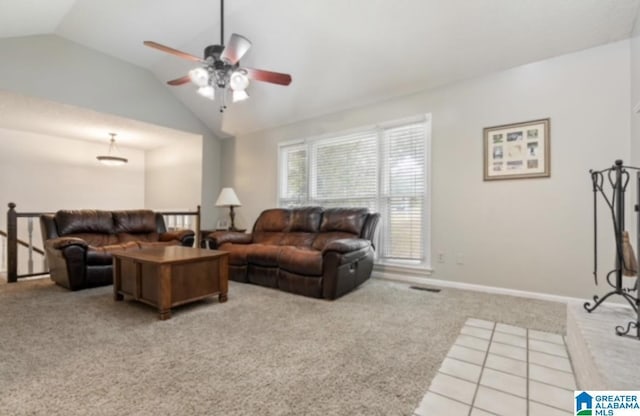 carpeted living room with ceiling fan and vaulted ceiling