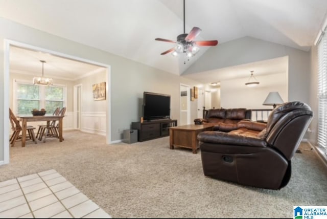 carpeted living room featuring crown molding, ceiling fan with notable chandelier, and vaulted ceiling