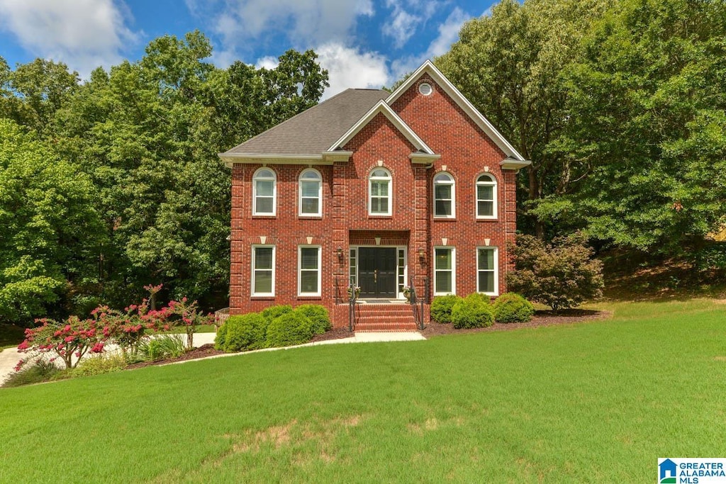 colonial home with a front yard