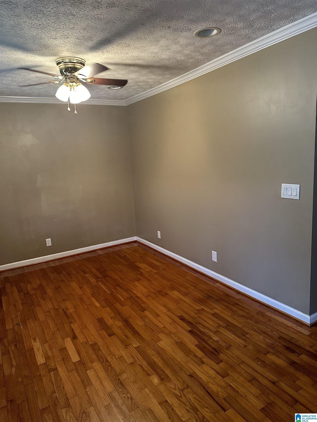 empty room featuring ceiling fan, ornamental molding, and hardwood / wood-style floors