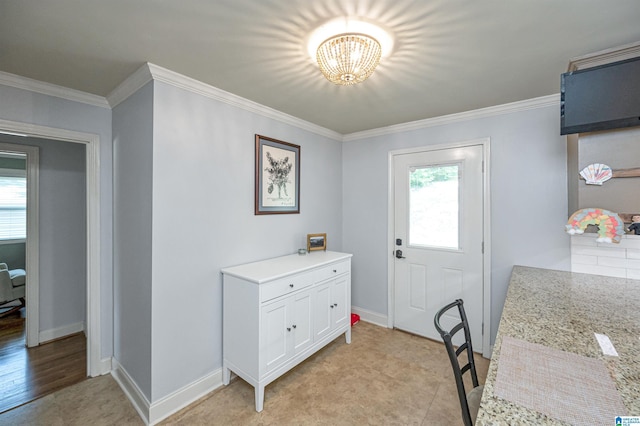 entrance foyer with crown molding, a wealth of natural light, and a notable chandelier