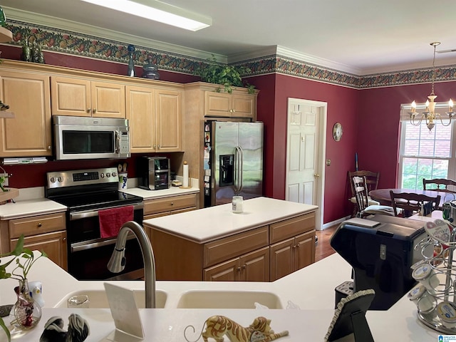 kitchen featuring pendant lighting, appliances with stainless steel finishes, a center island, a notable chandelier, and ornamental molding