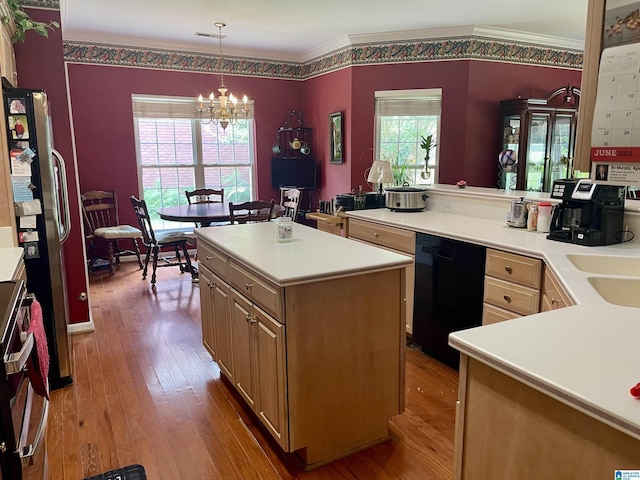 kitchen with dishwasher, hardwood / wood-style floors, a center island, ornamental molding, and decorative light fixtures