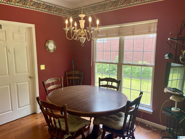 dining area featuring hardwood / wood-style floors and an inviting chandelier