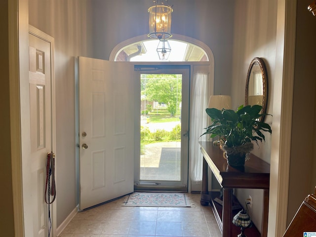 tiled foyer entrance featuring a chandelier