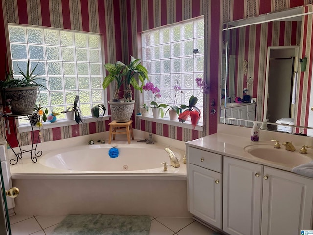 bathroom featuring vanity, a bathtub, and a wealth of natural light