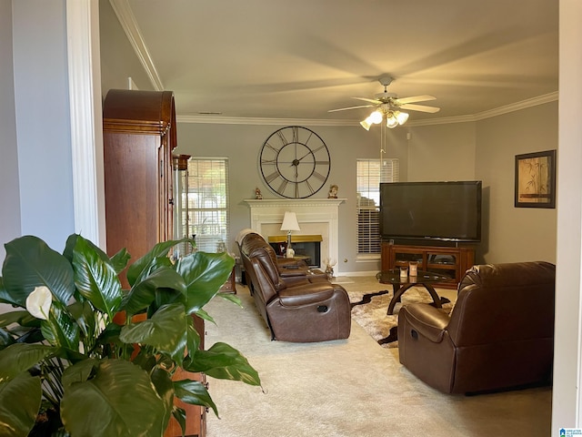 carpeted living room with ornamental molding and ceiling fan