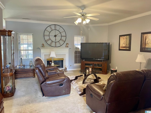 carpeted living room featuring ornamental molding and ceiling fan