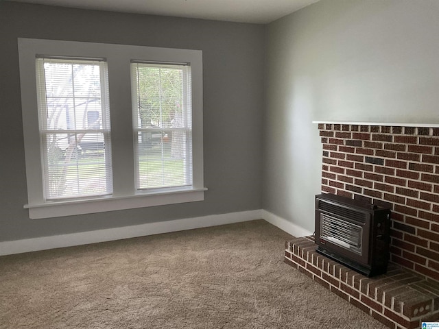 unfurnished living room with heating unit, carpet floors, and a wood stove