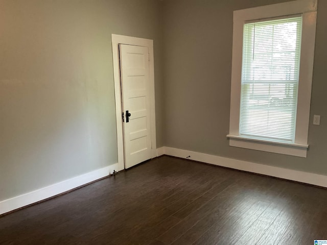 empty room with dark hardwood / wood-style floors