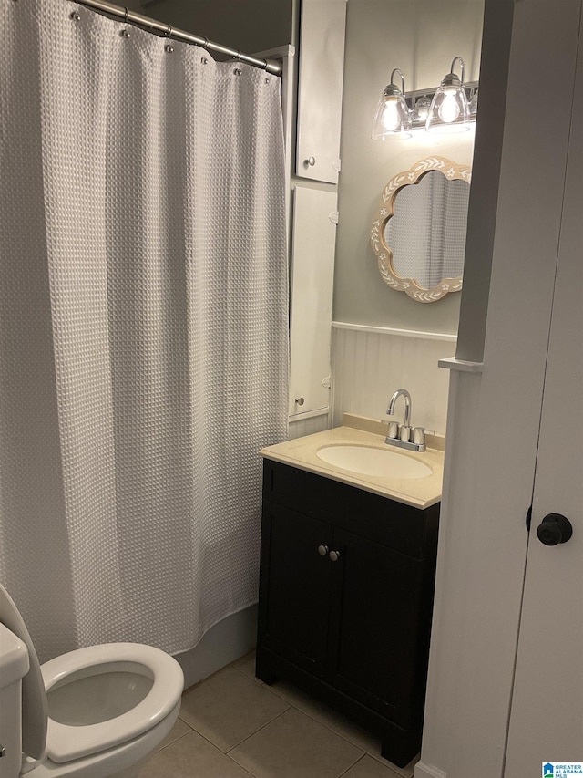 bathroom featuring tile patterned flooring, vanity, and toilet