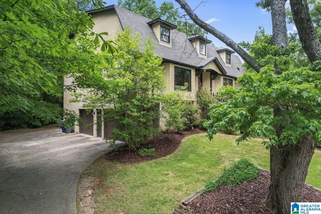 view of front of property with a garage and a front lawn