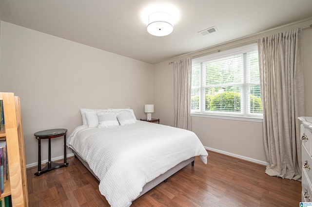 bedroom featuring dark hardwood / wood-style flooring