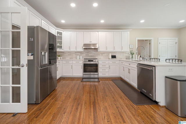 kitchen featuring sink, appliances with stainless steel finishes, hardwood / wood-style flooring, and white cabinets