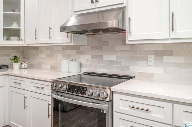 kitchen with stainless steel range with electric cooktop, white cabinetry, and decorative backsplash