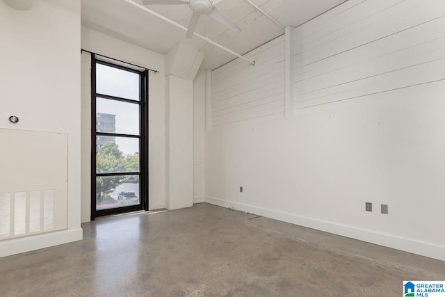 unfurnished room with concrete flooring