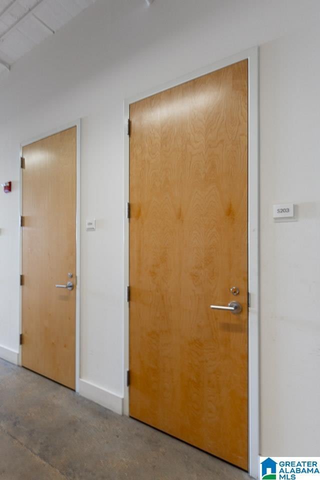 hallway with concrete flooring