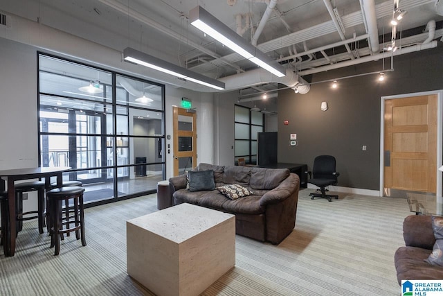 carpeted living room with a high ceiling