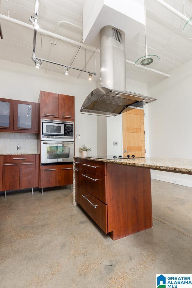 kitchen with stainless steel appliances and island exhaust hood