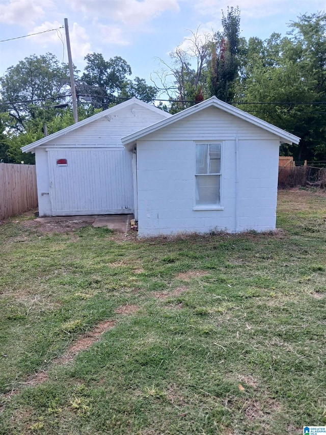 back of house with a lawn