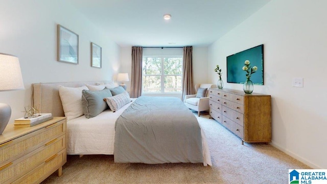 bedroom featuring light carpet